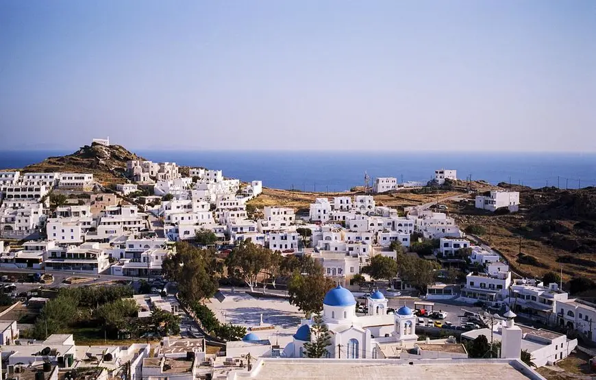panorama-di-ios-isola-greca-con-le-case-bianche-cicladiche-e-una-basilica-con-le-cupole-blu-davanti-dietro-il-mare